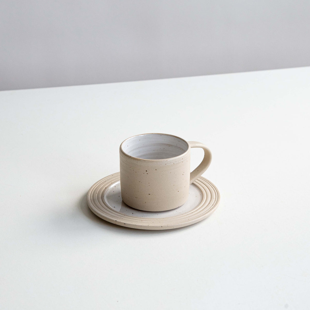 WHITE SPECKLED CUP & SAUCER